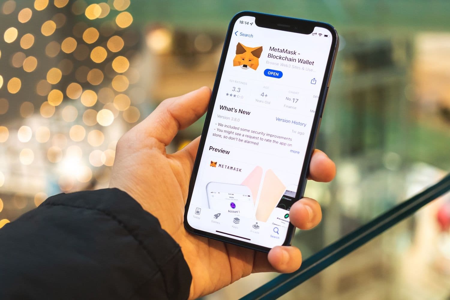 MetaMask Card placed beside a smartphone displaying governance token balances, illustrating crypto rewards and DeFi participation.